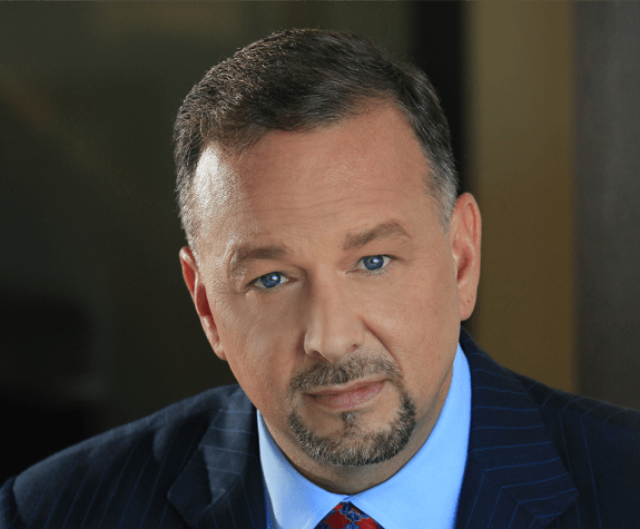 A close up portrait of a man in a suit 